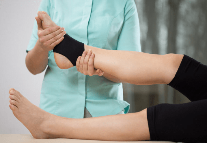 A therapist examinig an ankle